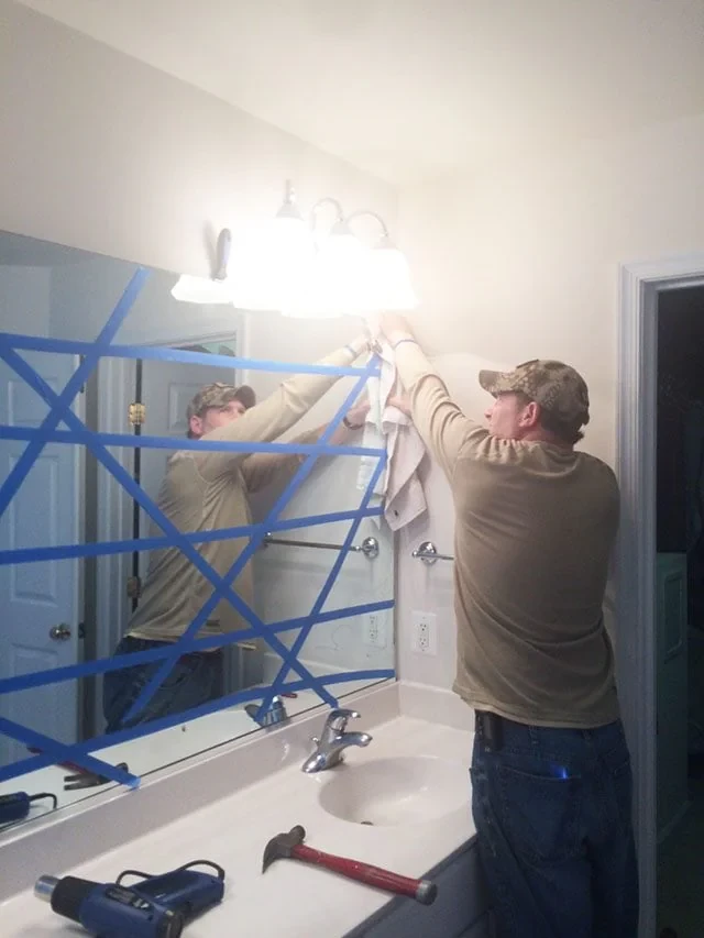Man Cleaning Bathroom Light Pinellas County Florida