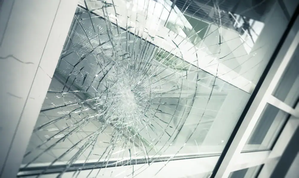 Broken glass window with shattering effect, repair and replacement services for glass doors and windows.