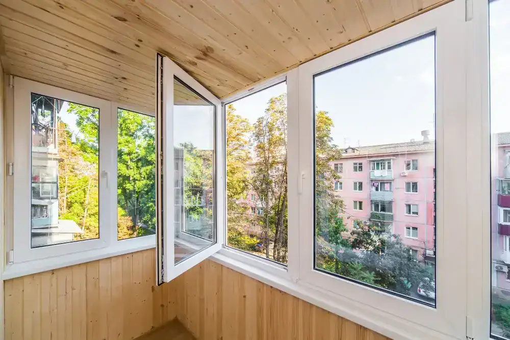 High-quality double-glazed window replacement on a balcony, featuring energy-efficient glass and modern design, ideal for homes or offices requiring expert glass and door repair services.