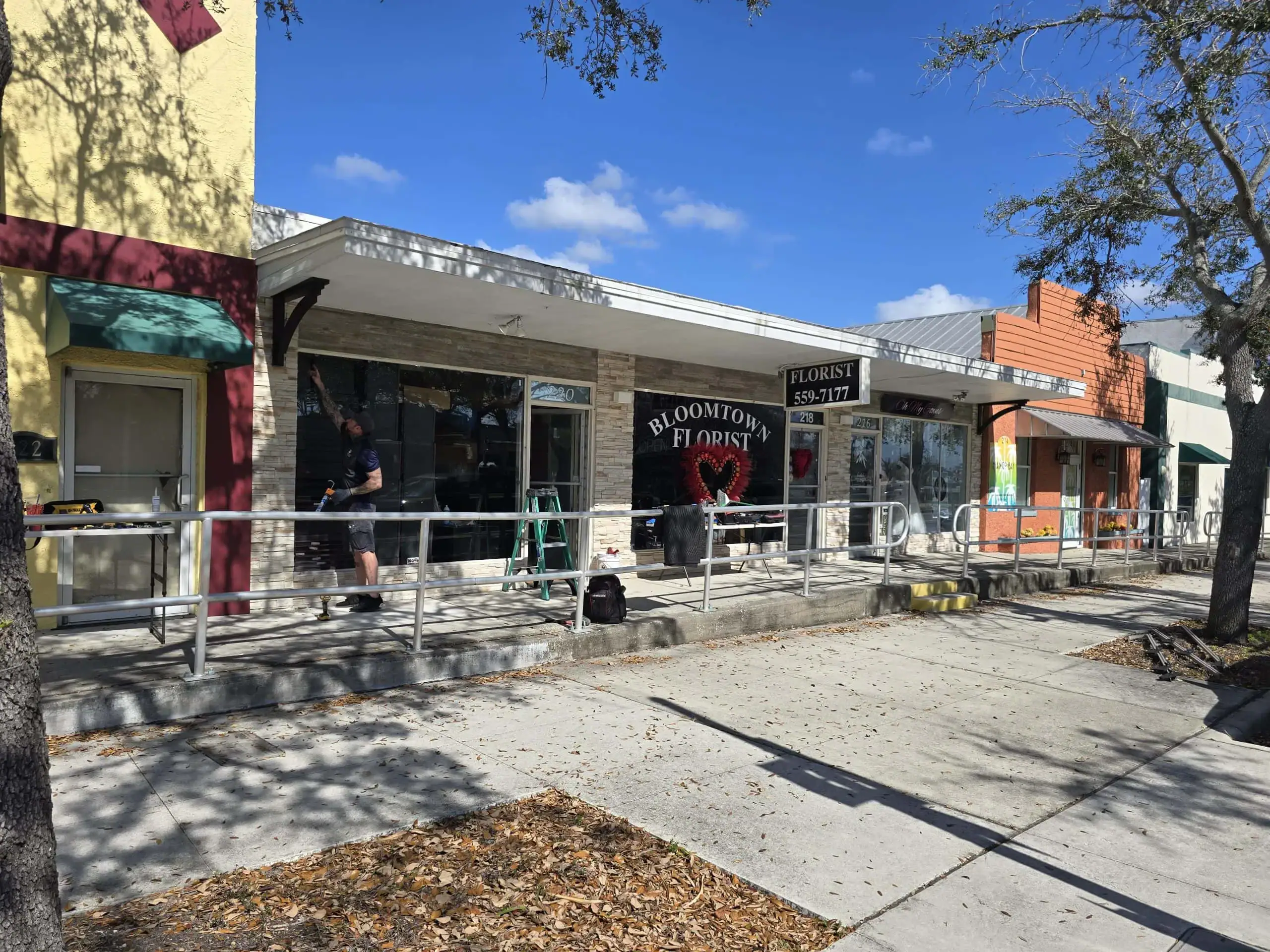 Broken window repair service at Bloomtown Florist storefront. Skilled technicians specialize in glass repairs, door glass replacement, and emergency glass services for commercial and residential properties.