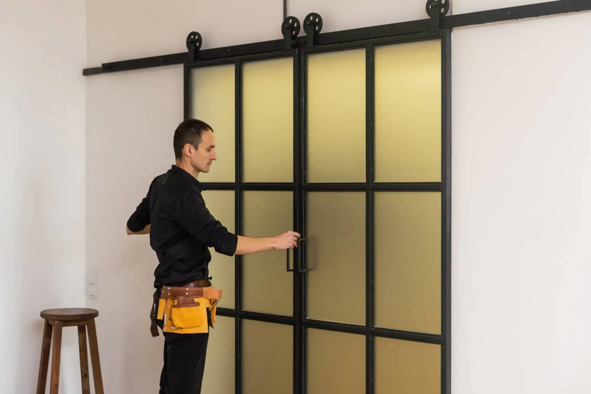 Shattered glass door being repaired by technician, emergency glass repair service, professional glass replacement, fast door repair, residential and commercial glass solutions.